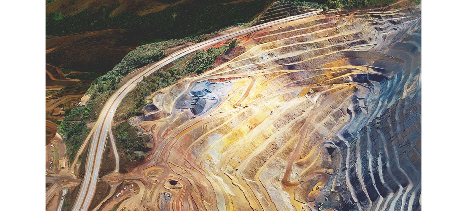 Drone-mapped open pit mine with colored terraces